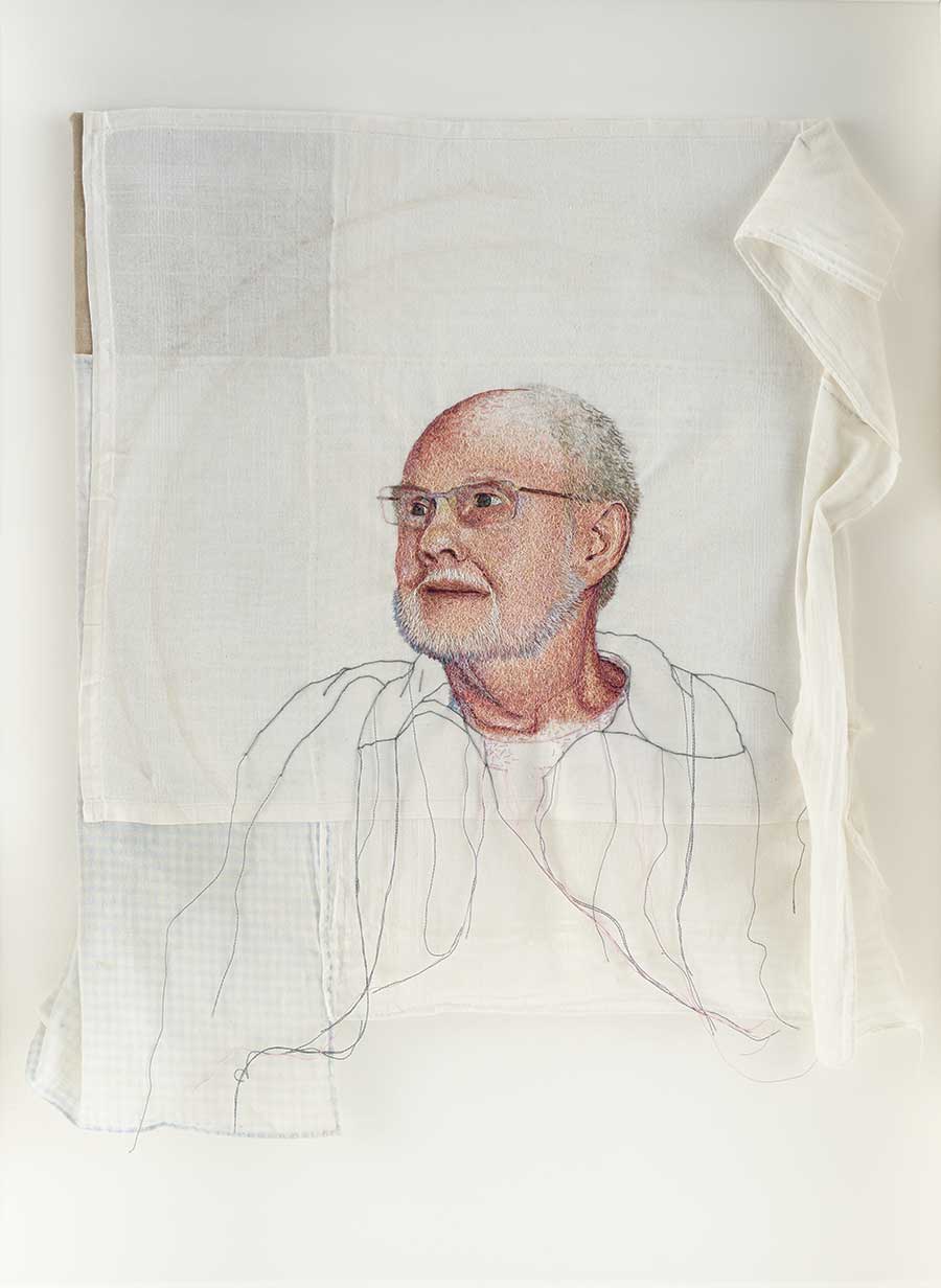 Embroidered Portrait On Fabric Surface.